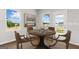 Cozy dining area featuring a round table set for four, with natural light from nearby windows at 214 Kindness Cir, Mcdonough, GA 30252