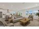 Open-concept living area combining a living room and kitchen with modern furnishings and bright lighting at 214 Kindness Cir, Mcdonough, GA 30252