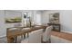 Formal dining room features a wooden table with seating for six guests and neutral decor at 214 Kindness Cir, Mcdonough, GA 30252