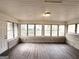Sunroom features brick walls and wood-look flooring at 1271 Avonwood Sw Cir, Atlanta, GA 30311