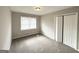 Well-lit bedroom with neutral carpeting and double-door closet at 1931 Sandringham Sw Dr, Atlanta, GA 30311