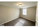 Spacious bedroom with carpet, window blinds, and door at 1931 Sandringham Sw Dr, Atlanta, GA 30311
