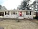 Charming ranch home with a red front door and landscaped yard at 2284 Headland Dr, East Point, GA 30344