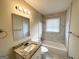 Updated bathroom with granite vanity and marble tile shower/tub at 490 Woods Dr, Atlanta, GA 30318