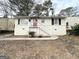 Newly painted Ranch home with red front door and steps at 490 Woods Dr, Atlanta, GA 30318
