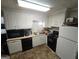 White kitchen with black appliances at 1617 Corona Dr, Austell, GA 30168