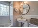 Bright bathroom with pedestal sink, subway tile, and a glass block window at 260 Lawrenceville St, Mcdonough, GA 30253