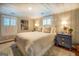 Bright bedroom with a cozy bed, nightstands, and window shutters at 260 Lawrenceville St, Mcdonough, GA 30253