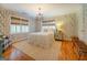 Bedroom with hardwood floors, leaf patterned wallpaper and chandelier at 260 Lawrenceville St, Mcdonough, GA 30253