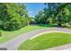 Landscaped front yard with circular driveway and mature trees at 260 Lawrenceville St, Mcdonough, GA 30253