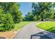 Landscaped front yard with a curved driveway at 260 Lawrenceville St, Mcdonough, GA 30253