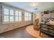 Sunroom with wicker furniture, gallery wall, and access to the backyard at 260 Lawrenceville St, Mcdonough, GA 30253