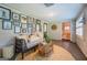 Sunroom with wicker furniture, gallery wall, and access to the backyard at 260 Lawrenceville St, Mcdonough, GA 30253