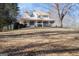 House on a hill with large yard and surrounding trees at 1885 Jenny Ln, Lithia Springs, GA 30122