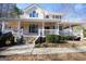 Two-story house with wraparound porch and stone accents at 1885 Jenny Ln, Lithia Springs, GA 30122
