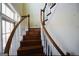 Elegant curved staircase with wooden railing and steps at 1885 Jenny Ln, Lithia Springs, GA 30122