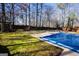 Residential inground pool with pool cover in backyard at 1885 Jenny Ln, Lithia Springs, GA 30122