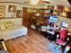 Bedroom featuring daybed, office setup, and wood floors at 3919 Evans Rd, Cumming, GA 30040