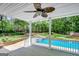 View of backyard, flower garden and pool area from covered back porch with ceiling fan at 90 Barrington Grange Dr, Sharpsburg, GA 30277