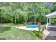 Inviting backyard with lush landscaping, swimming pool, and patio area at 90 Barrington Grange Dr, Sharpsburg, GA 30277