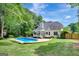 Well-maintained backyard featuring an in-ground pool, patio, and mature trees at 90 Barrington Grange Dr, Sharpsburg, GA 30277