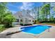 Private backyard with in-ground pool, diving board, and covered patio at 90 Barrington Grange Dr, Sharpsburg, GA 30277