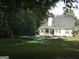 Beautiful backyard featuring a private pool, expansive lawn, and covered patio, perfect for outdoor entertaining at 90 Barrington Grange Dr, Sharpsburg, GA 30277
