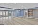 Spacious basement with neutral paint, a decorative ceiling, wood-look flooring, and access to the outside at 90 Barrington Grange Dr, Sharpsburg, GA 30277