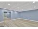 Finished basement space with recessed lighting, vinyl flooring, and decorative paneled ceiling at 90 Barrington Grange Dr, Sharpsburg, GA 30277