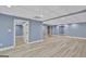 Spacious finished basement featuring recessed lights, vinyl floors, and built-in shelving at 90 Barrington Grange Dr, Sharpsburg, GA 30277