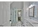 Well-lit bathroom with a glass shower, soaking tub, and double vanity sinks at 90 Barrington Grange Dr, Sharpsburg, GA 30277