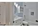 Stylish bathroom with modern fixtures, including a vanity with a sink and a tub with a shower, offering a spa-like experience at 90 Barrington Grange Dr, Sharpsburg, GA 30277