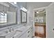 Bathroom featuring double sinks, marble countertops, and modern fixtures at 90 Barrington Grange Dr, Sharpsburg, GA 30277