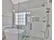 Modern bathroom with glass shower, standalone tub, and white marble tiling at 90 Barrington Grange Dr, Sharpsburg, GA 30277