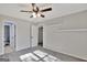 Carpeted bedroom featuring a ceiling fan and two doorways, creating an airy and flexible living space at 90 Barrington Grange Dr, Sharpsburg, GA 30277