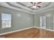 Bright bedroom featuring trey ceilings, hardwood floors, and view into bathroom at 90 Barrington Grange Dr, Sharpsburg, GA 30277