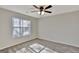Bedroom with ceiling fan and natural light from the window illuminates the neutral walls and plush carpeting at 90 Barrington Grange Dr, Sharpsburg, GA 30277