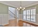 Elegant dining room with hardwood floors open to the staircase and front door at 90 Barrington Grange Dr, Sharpsburg, GA 30277
