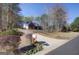 Two-story home exterior featuring a driveway, with surrounding trees and landscaping, and a mailbox at 90 Barrington Grange Dr, Sharpsburg, GA 30277