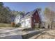 View of two-story home, including the garage, driveway, some landscaping, and wood privacy fence at 90 Barrington Grange Dr, Sharpsburg, GA 30277
