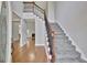 Grand foyer featuring hardwood floors, a staircase with iron spindles, and lots of natural light at 90 Barrington Grange Dr, Sharpsburg, GA 30277