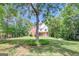 Charming two-story traditional-style home with mature trees providing shade on a well-manicured lawn at 90 Barrington Grange Dr, Sharpsburg, GA 30277