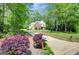 Inviting two-story house with a long driveway, mature landscaping, and a classic mailbox at 90 Barrington Grange Dr, Sharpsburg, GA 30277