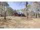 Traditional two-story brick home with a white columned porch and mature trees in a large front yard at 90 Barrington Grange Dr, Sharpsburg, GA 30277