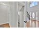 Hallway with hardwood floors and an open layout to the foyer with the staircase at 90 Barrington Grange Dr, Sharpsburg, GA 30277