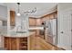 Modern kitchen design with wood cabinets, stainless steel appliances, granite countertops, and a convenient island at 90 Barrington Grange Dr, Sharpsburg, GA 30277