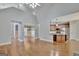 Open floor plan with hardwood floors, open to the kitchen with stainless appliances and island at 90 Barrington Grange Dr, Sharpsburg, GA 30277