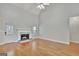Inviting living room with a cozy fireplace, hardwood floors, and ample natural light from the windows at 90 Barrington Grange Dr, Sharpsburg, GA 30277