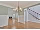Open-concept living area featuring hardwood floors and a traditional fireplace at 90 Barrington Grange Dr, Sharpsburg, GA 30277