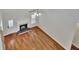 Open-concept living room with fireplace, hardwood floors, and ample natural light at 90 Barrington Grange Dr, Sharpsburg, GA 30277